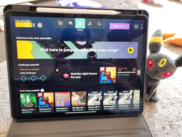 iPad showing Rocksmith+ home screen during user testing on a carpet surface