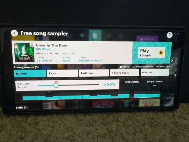 Phone in landscape showing Rocksmith+ song detail page with arrangement and difficulty controls