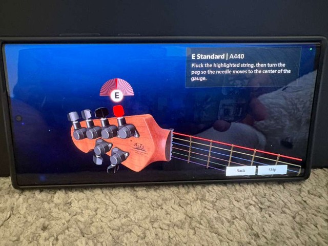 Phone in landscape showing Rocksmith+ 3D guitar tuning interface during user testing
