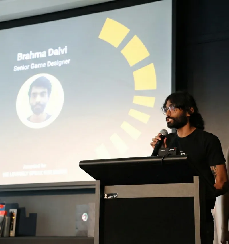 Bramha Dalvi speaking on stage at a conference